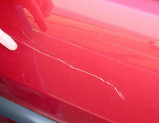 Red car with major scratches